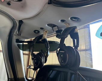 Headset hooks for a variety of aircraft.  example shown is a 2005 SR 22 utilizing the existing hardware for the headliner.