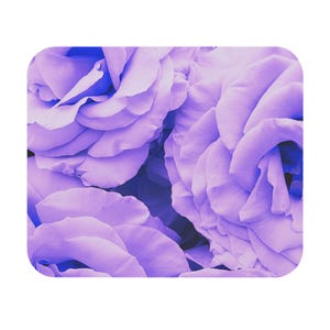 May include: Close-up of a bouquet of purple roses. The petals are soft and delicate, with a velvety texture. The roses are arranged in a cluster, creating a beautiful and romantic display.