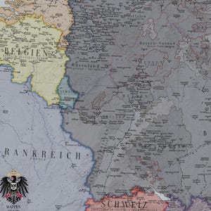 May include: A historical map showing regions of Europe including Belgium, Luxembourg, France, and parts of Germany. The map features text labels for countries and cities, a muted colour palette of grey, yellow, and pink, and a black eagle crest labelled WAPPEN.