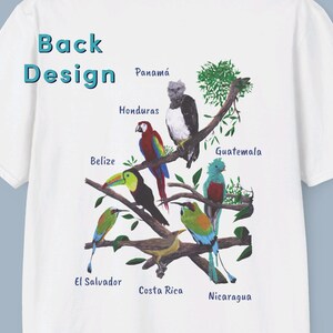 May include: White t-shirt with a colorful design of birds and branches. The countries of Central America are labeled on the branches, including Panama, Honduras, Belize, Guatemala, El Salvador, Costa Rica, and Nicaragua.