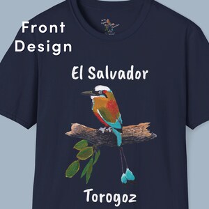 May include: A navy blue t-shirt with a white graphic of a colorful bird perched on a branch. The bird has a long, blue tail and is surrounded by green leaves. The text "El Salvador" and "Torogoz" are printed in white below the bird.