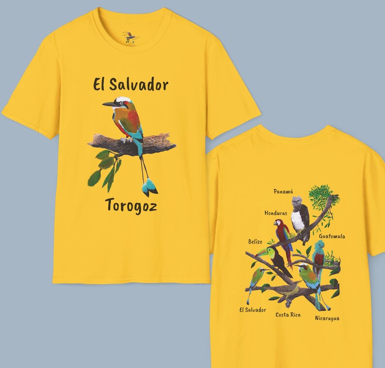 May include: Two yellow t-shirts with Central American bird and country names printed on them. The front shirt features a blue and green bird called a "Torogoz" with the text "El Salvador". The back shirt features a tree branch with various birds and the names of Central American countries: Panama, Honduras, Guatemala, Belize, El Salvador, Costa Rica, and Nicaragua.