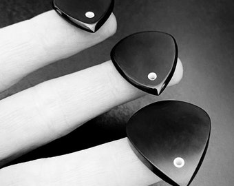 Handmade black guitar pick made of peek with glowing hole in shape of jazz and flow gift  unique designe are by Luka Plectrums - Singular
