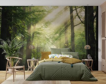 May include: A bedroom scene featuring a forest mural, a bed with olive green bedding, and a wooden chair. The bed has several pillows in shades of green and yellow. The room is decorated with a natural, earthy theme.
