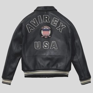 Men's black lamb leather Avirex bomber jacket with embroidered USA patches, varsity striped ribbed cuffs, and classic American flight jacket styling.