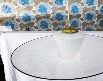May include: A white glass ceiling light fixture with a round, frosted glass shade and a gold metal base.