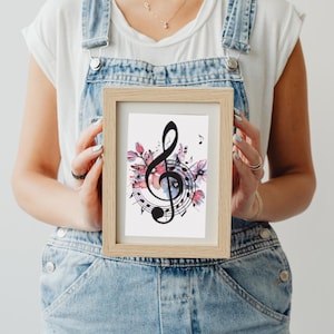 May include: A framed print featuring a black treble clef surrounded by watercolor flowers and musical notes. The flowers are pink, purple, and blue.