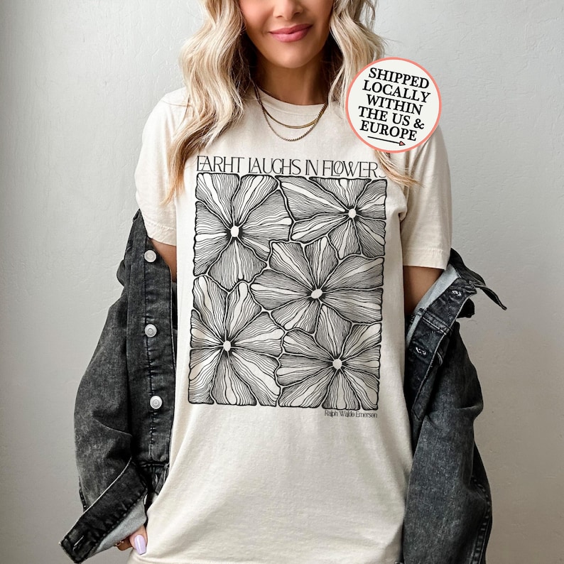 T-shirt printed with boho line art flowers and a poet Ralph Waldo Emerson's quote about the beauty and the miracle of flowers:"Earth laughs in flowers".