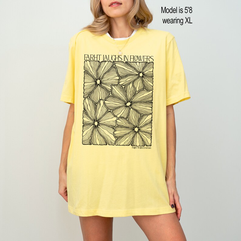 May include: A yellow t-shirt with a black graphic of flowers and the text "EARTH LAUGHS IN FLOWERS" and "People. Plants. Emerson."