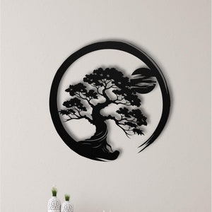 May include: Black metal wall art featuring a stylized silhouette of a bonsai tree with a circle around it. The tree is in the center of the circle and has a moon shape in the background.