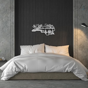 North Carolina state outline metal sign displayed in a modern home bedroom.