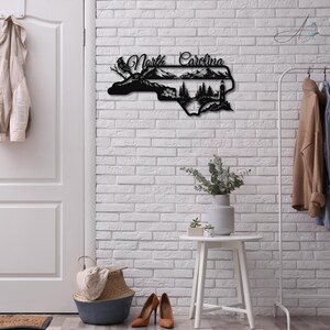 North Carolina state outline metal sign displayed in a modern home entryway.