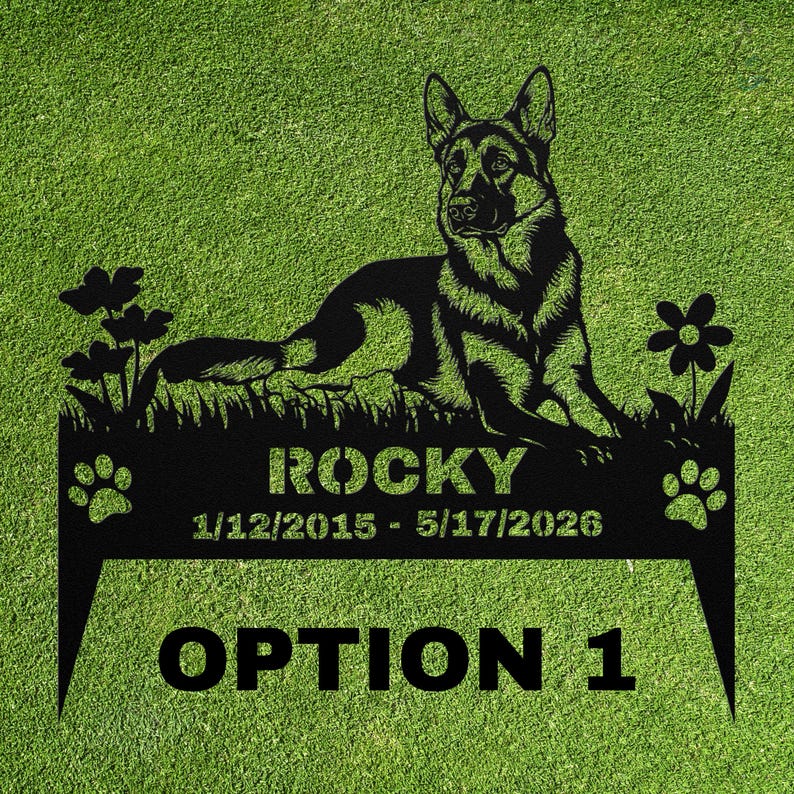 May include: A black metal garden stake featuring a German Shepherd silhouette lying in grass with flowers. The text reads ROCKY, 1/12/2015 - 5/17/2026, and OPTION 1, flanked by two paw prints. The design includes two pointed stakes at the bottom.