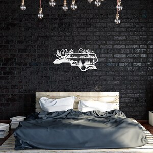 North Carolina state outline metal sign displayed in a rustic home bedroom.