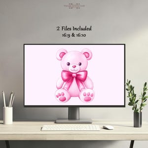 May include: A pink teddy bear illustration with a large pink bow on a computer screen. The screen displays the text "2 Files Included 16:9 & 16:10". The image is on a desk with a keyboard, mouse, and a small plant.