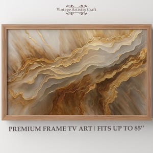 May include: Abstract art print in a wooden frame. The artwork features a layered design with shades of brown, gold, and beige. The text at the bottom reads "PREMIUM FRAME TV ART | FITS UP TO 85". The top text reads "Vintage Artistry Craft".