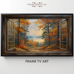 May include: A framed canvas print of a painting depicting a window view of a forest scene with a lake in the distance. The trees are in autumn colours of red, orange, and yellow. The window frame is brown and weathered.
