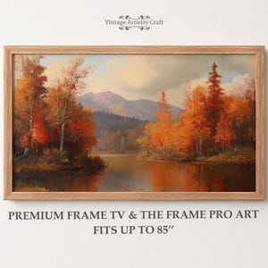 May include: A landscape painting in a light wood frame depicting a lake surrounded by autumn trees with orange and red foliage, with mountains in the background. Text reads: Vintage Artistry Craft, PREMIUM FRAME TV & THE FRAME PRO ART FITS UP TO 85".