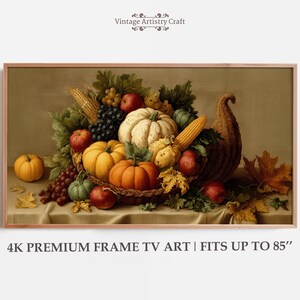May include: A still-life painting of a cornucopia overflowing with autumn harvest items. The arrangement includes pumpkins, apples, grapes, and corn. The text at the bottom reads "4K PREMIUM FRAME TV ART | FITS UP TO 85".