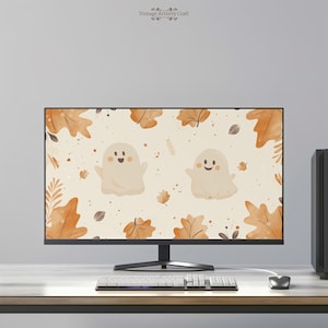 Może przedstawiać: Monitor komputera wyświetlający cyfrową ilustrację dwóch przyjaznych duchów z uśmiechającymi się twarzami na tle pomarańczowych i brązowych jesiennych liści. Tekst "Vintage Artistry Craft" jest wyświetlany u góry ekranu.