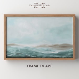 May include: A framed abstract painting of a seascape with a light blue and gray color scheme. The painting depicts a horizon with rolling waves and a cloudy sky. The frame is a light brown wood.