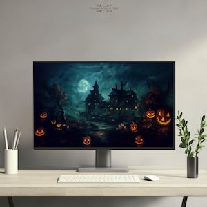 May include: A computer monitor displaying a Halloween-themed image of a spooky house with a full moon in the background.  The house is lit with warm yellow lights and there are jack-o'-lanterns scattered in the foreground.