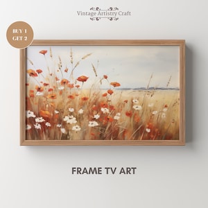 Pode incluir: Uma pintura emoldurada de um campo de flores silvestres com um céu azul ao fundo. As flores são principalmente laranja e branco, com alguma grama verde e caules marrons. A pintura está em uma moldura de madeira.