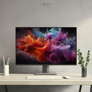 May include: A modern computer monitor with a black frame and a silver stand. The monitor is displaying a colorful abstract image of swirling smoke. The monitor is on a light wood desk with a white keyboard and a white mouse.