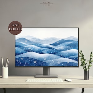 May include: A computer monitor displaying a digital illustration of a snowy mountain landscape with blue and white hues. The monitor is on a desk with a white keyboard and a white mouse.