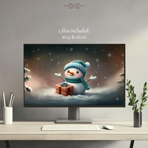 May include: A digital illustration of a snowman holding a gift box in a snowy winter scene. The snowman is wearing a blue hat and scarf. The text "2 files included: 16x9 & 16x10" is displayed above the image.