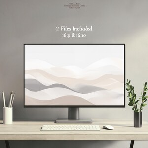 May include: A computer monitor displays a digital art print of abstract, layered mountain-like shapes in neutral tones of beige, gray, and white. The text "2 Files Included 16:9 & 16:10" is visible. The monitor sits on a wooden desk with a keyboard, mouse, pencils, and a plant.