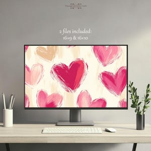 Puede incluir: Un fondo de escritorio digital con un patrón de corazones rosas y rojos sobre un fondo crema. El texto "2 archivos incluidos: 16x9 & 16x10" se muestra en la parte superior de la imagen.