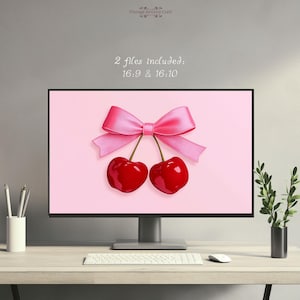 May include: Two red cherries tied together with a pink bow on a pink background. The image is a digital download of a desktop wallpaper.