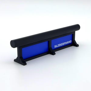May include: A black and blue rectangular object with the text "SLIDEOFHAND" in white. The object has a rounded top and two blue panels. The base is black and has a support structure.