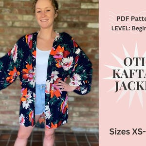 May include: A navy blue kaftan jacket with a vibrant floral pattern in orange, white, and pink. The image also includes text that reads "OTI KAFTAN JACKET" and "Sizes XS-XXL". The pattern is set against a dark background.