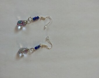 May include: A pair of silver earrings with blue beads and clear teardrop-shaped glass charms.