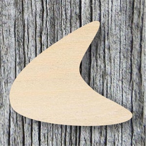 May include: A light brown wooden cutout in the shape of a boomerang. The cutout is on a woodgrain background.