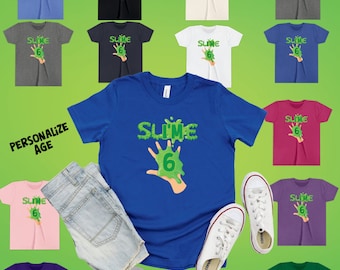 May include: A blue toddler t-shirt with a green slime handprint and the text "Slime 6". The shirt is available in a variety of colors, including pink, purple, gray, green, black, white, and navy blue.