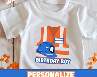 May include: White t-shirt featuring an orange construction vest and blue hard hat graphic. The vest has a name tag that reads "Handyman". The text "Birthday Boy" is printed below the graphic. The number "4" is on the hard hat.