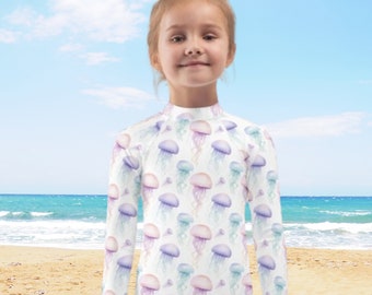 Maglietta protettiva anti-UV per bambini, ideale per nuoto e protezione solare, con fantasie personalizzate uniche.