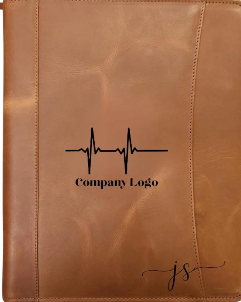 May include: A brown leather portfolio with a black heartbeat graphic and the text "Company Logo". The portfolio has a stitched border and the initials "js" in the bottom right corner.