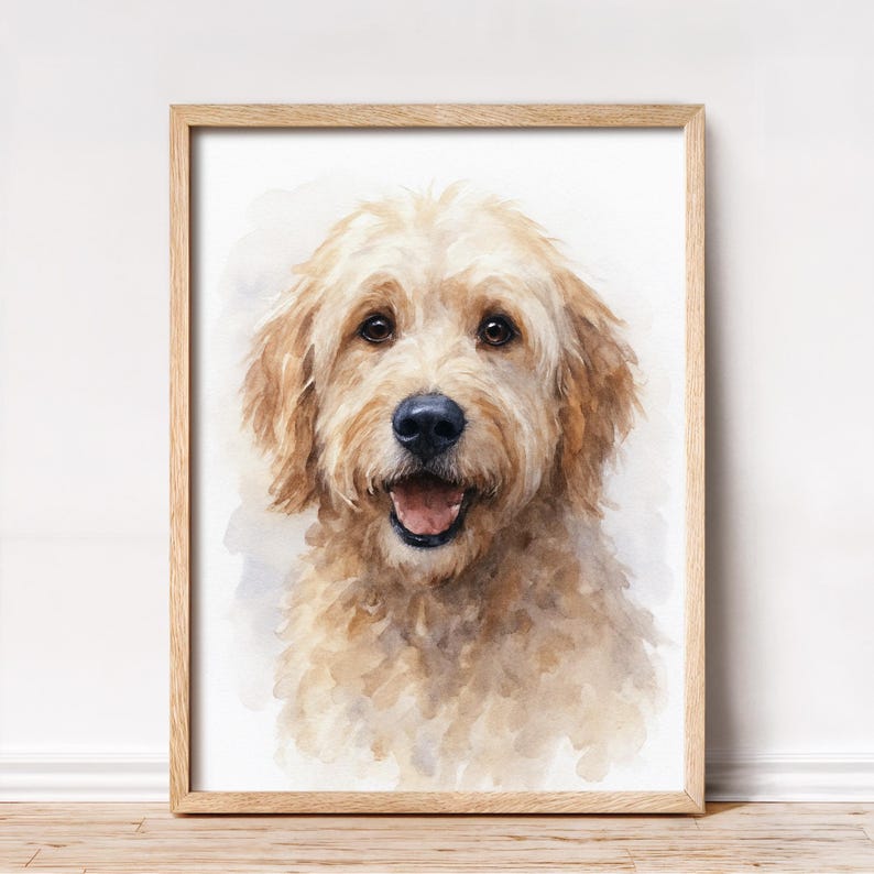 May include: Watercolor portrait of a golden doodle dog with a happy expression. The dog has light brown fur, a black nose, and brown eyes. The artwork is framed in a light brown wooden frame.