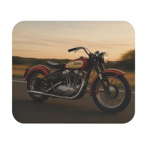 May include: A red and chrome vintage motorcycle with the word "Sprite" on the gas tank. The motorcycle is on a paved road with a blurred background of a sunset.