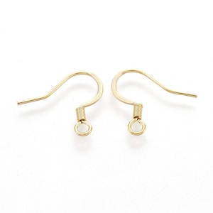 May include: A pair of gold-toned earring hooks with a spring-loaded closure. The hooks are made of metal and have a smooth finish.