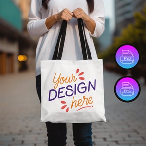 Könnte beinhalten: Eine weiße Einkaufstasche mit schwarzen Henkeln. Die Tasche hat den Text "Your DESIGN here" in einer bunten, handschriftlichen Schrift aufgedruckt.