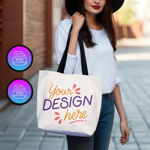 Könnte beinhalten: Eine weiße Einkaufstasche mit schwarzen Henkeln. Die Tasche hat den Text "Your DESIGN here." in bunten Buchstaben aufgedruckt.