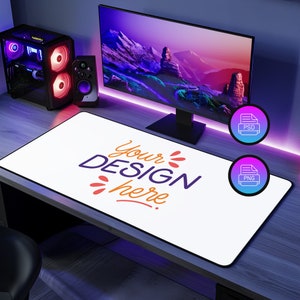 May include: A white desk mat with a black border and the text "Your DESIGN here" in colorful lettering. The mat is on a wooden desk with a computer monitor, speakers, and a gaming PC in the background.