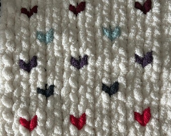 Eggshell cream coloured chunky knit animal blanket with multi coloured hearts.