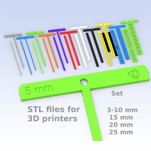 May include: A set of 10 colorful plastic T-shaped rulers, ranging in size from 3 to 25 mm. The rulers are designed for 3D printing and are labeled with the measurements in millimeters. The set includes a green ruler with the text "5 mm" and "Set" printed on it.