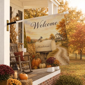 May include: A rectangular garden flag featuring the word Welcome in script, a mailbox labeled Henderson with a bird perched on top, pumpkins, and a country house scene with autumn trees, hanging from a black metal bracket on a porch.